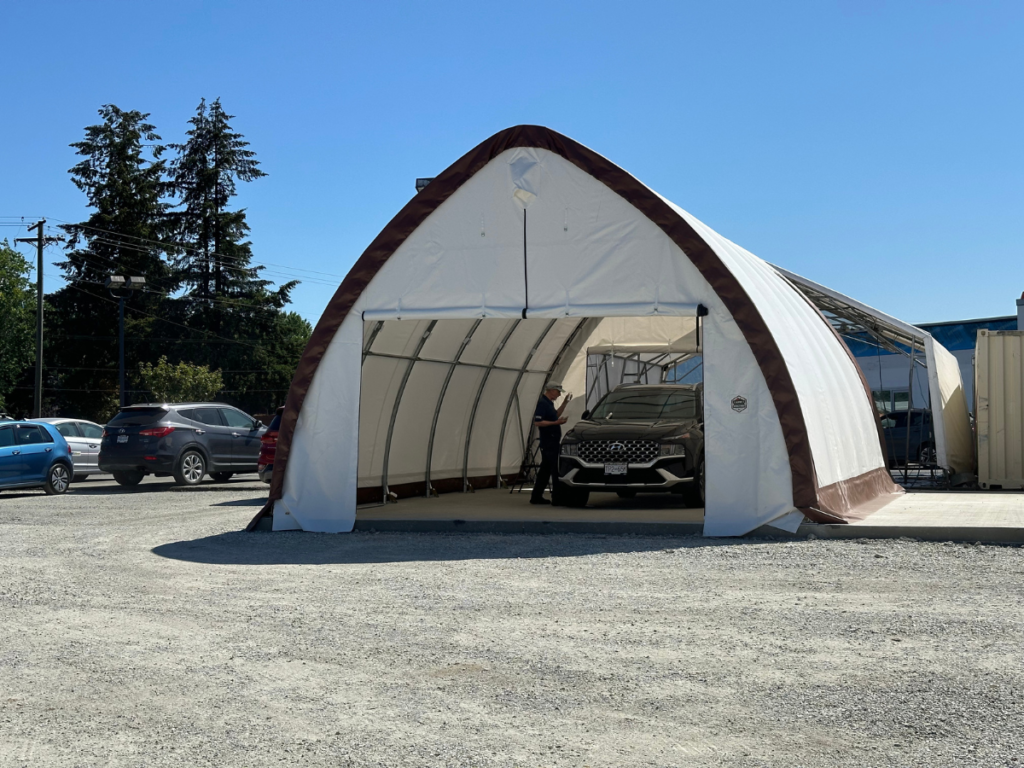 A fabric-covered car wash bay installed at a Hyundai dealership, providing a dedicated, weather-protected space for vehicle detailing and maintenance.