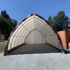 Durable arched PVC fabric shelter with brown trim, ideal for storage, vehicle protection, and weather-resistant coverage in Canada.